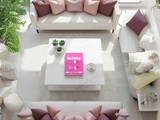 Modern living room with a pink book on a white coffee table